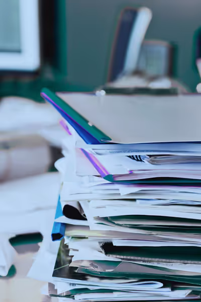 A large piles of messy files on a desk