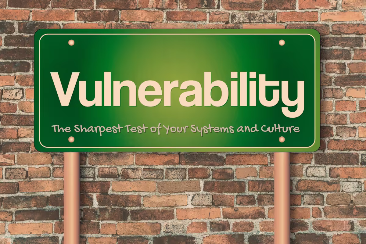A street sign reading 'Vulnerability' and underneath text reading 'The sharpest test of your systems and culture'