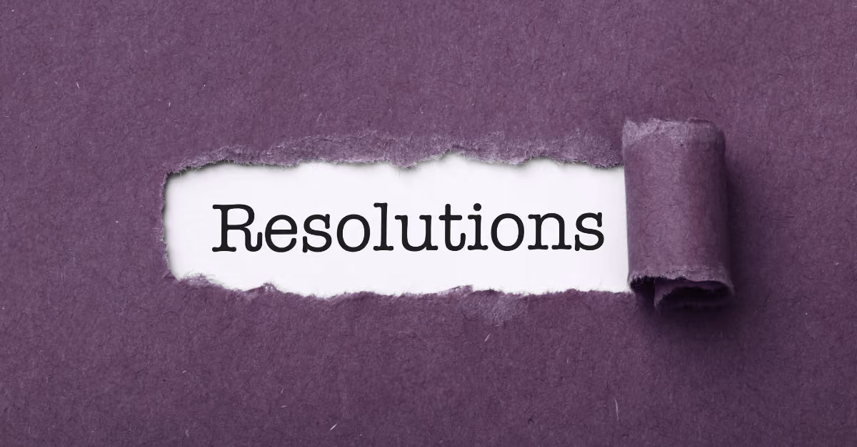 Purple torn paper revealing the word Resolutions on a white background